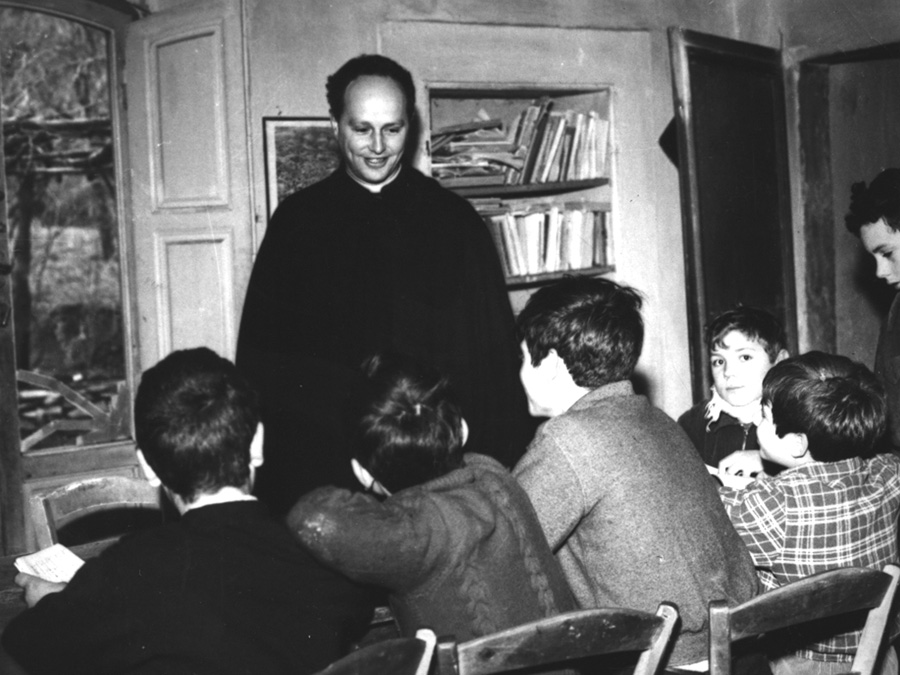 Don Milani with his pupils in the School of Barbiana